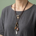 Feather pendant with leather chain necklace