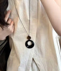Black and brown stone pendant with leather chain necklace